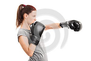 Young girl with boxing gloves punching