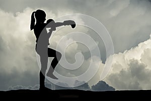 Young girl boxing at sunset.
