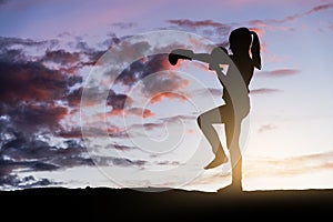 Young girl boxing at sunset.