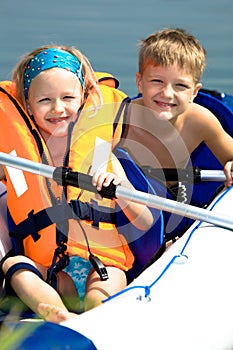 Young girl and boy at a lake