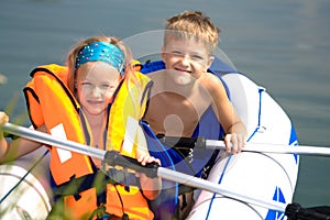 Young girl and boy at a lake