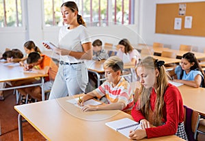 Young girl and boy studying subject in classroom