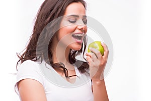 Young girl with brances eat apple. Female teeth with dental braces and apple.