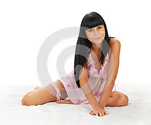 Young girl - brunette on white bed