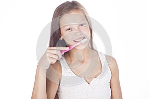 Young girl is brushing her teeth. photo