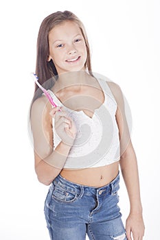 Young girl is brushing her teeth. photo