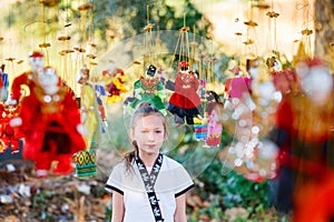 Young girl with burmese string puppets