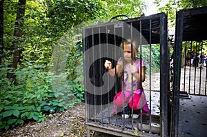 Young girl in cage