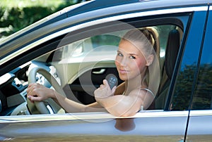 Young girl in car with car key