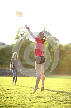 Young girl is catching a frisbee