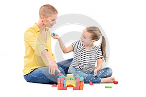 Young girl in child occupational therapy session doing sensory playful exercises with her therapist. Child therapy concept. photo