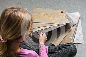 Young girl choosing vinil floor