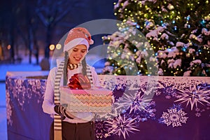 Young girl on Christmas Eve under the Christmas tree