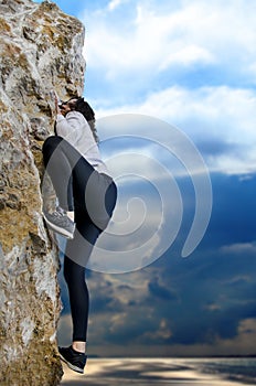 Young girl climbing on a limestone wall