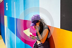Young girl on coloured wall