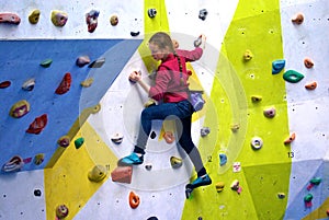 Young girl on a colourful climbing wall