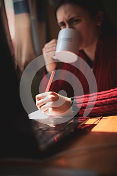 Young girl with confused look on her face looking at computer studying at home