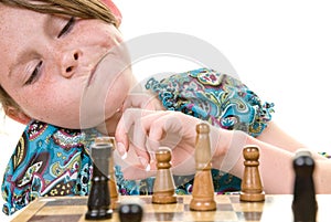 Young girl considering chess move