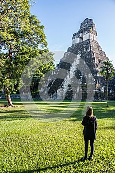 Young Girl Contemplating Mayan Ruins at Tikal, National Park. Tr