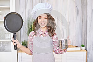 Young girl cooking kitchen. Curly pretty child portrait. Chef christmas student