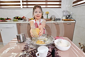 Young girl cooking a pastry