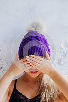 Young girl covering her eyes over white background waiting for the surprise gift for birthday