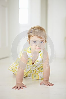 Young Girl Crawling On Floor In Bedroom