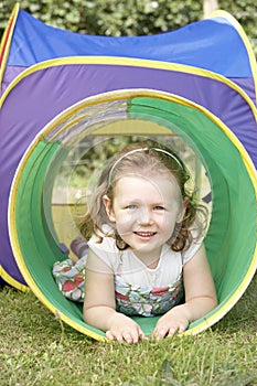 Young Girl Crawling Through Play Equipment