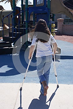 Young Girl with Crutches at Playground