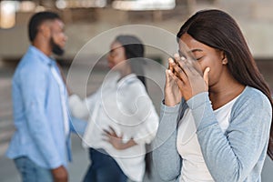 Young girl crying watching her ex boyfriend happy with another woman