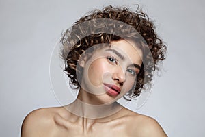 Young girl with curly hair and natural makeup