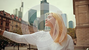 Young girl dancer ballerina blonde dancing on street of modern city metropolis