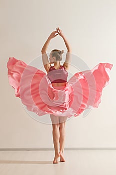 Young girl dancing in beautiful pink dress