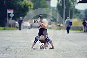 Young girl dancing breakdance on the street