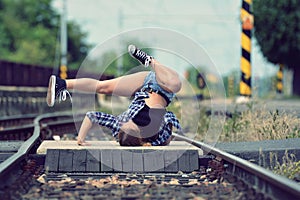 Young girl dancing breakdance on the street