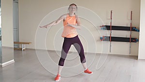 Young girl dancing zumba in gym or studio. fitness, sport, dance and lifestyle concept