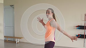 Young girl dancing zumba in gym or studio. slow motion. fitness, sport, dance and lifestyle concept