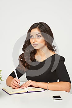 A young girl with dark hair, a black dress