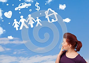 Young girl daydreaming with family and household clouds