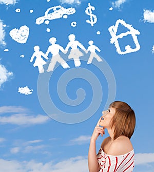 Young girl daydreaming with family and household clouds