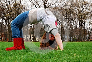 A young girl demonstrates a backbend