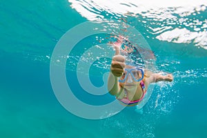 Young girl diving underwater