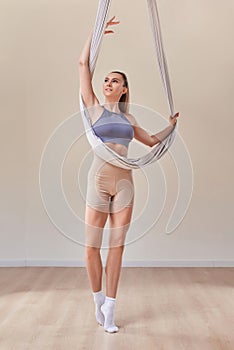 Young girl do fly yoga and stretches,yoga training, fly yoga, aerostretching, aerial yoga hammock,pilates therapy concept