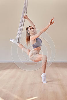 Young girl do fly yoga and stretches,yoga training, fly yoga, aerostretching, aerial yoga hammock,pilates therapy concept