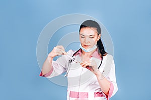 Young girl doctor with a syringe in hand