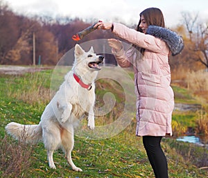 Young girl with dog running at the forest