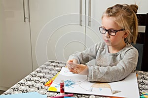 Young girl doing art work with paper