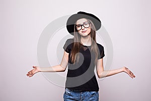 Young girl doing emotion. Dressed in a black shirt, black hat, glasses.