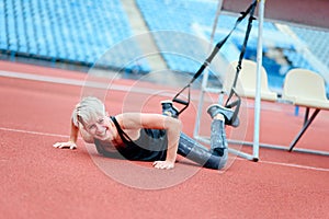 Young girl doing exercises with TRX loop. ShÑƒ laughter