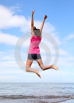 Young girl while doing gymnastic exercises and jumping very high
